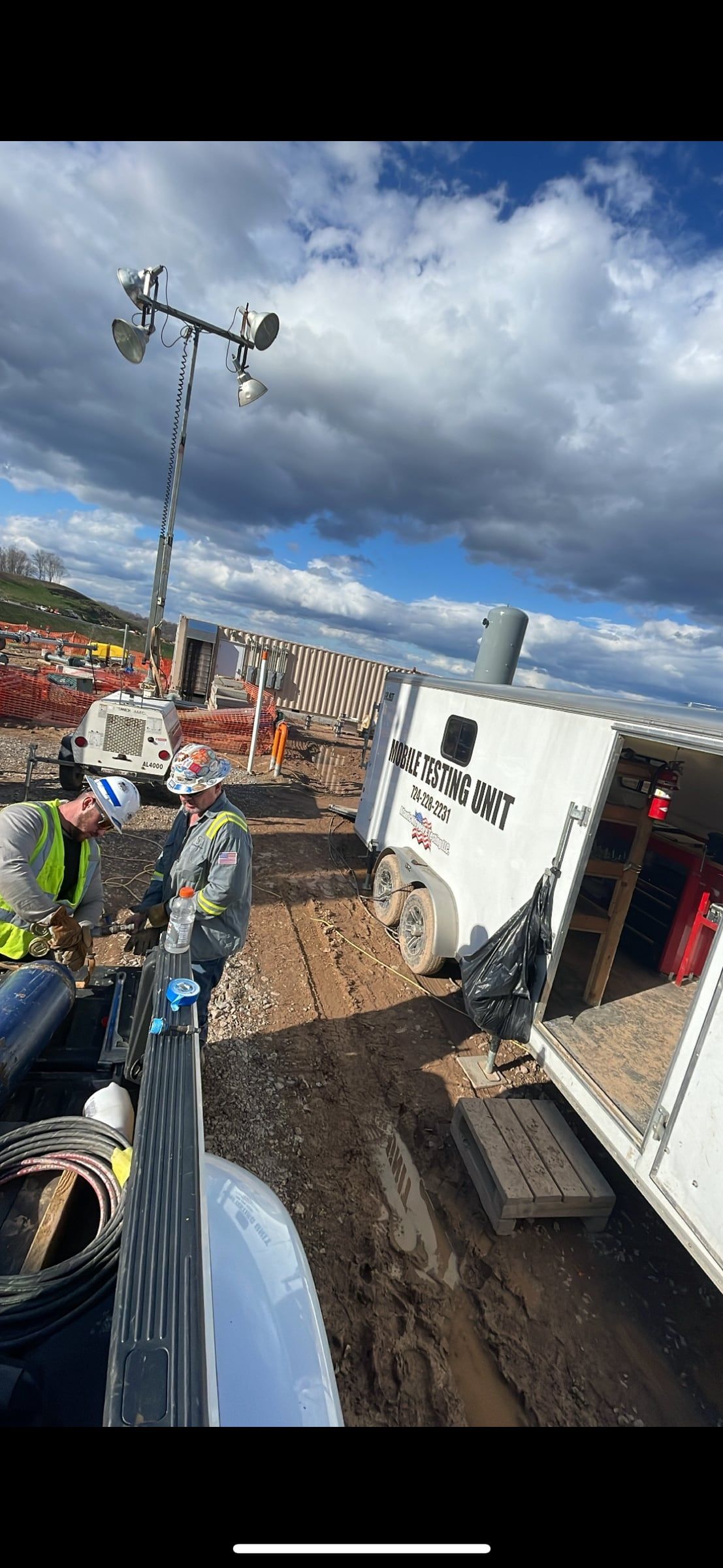 Crew working out of the testing unit on a muddy pad