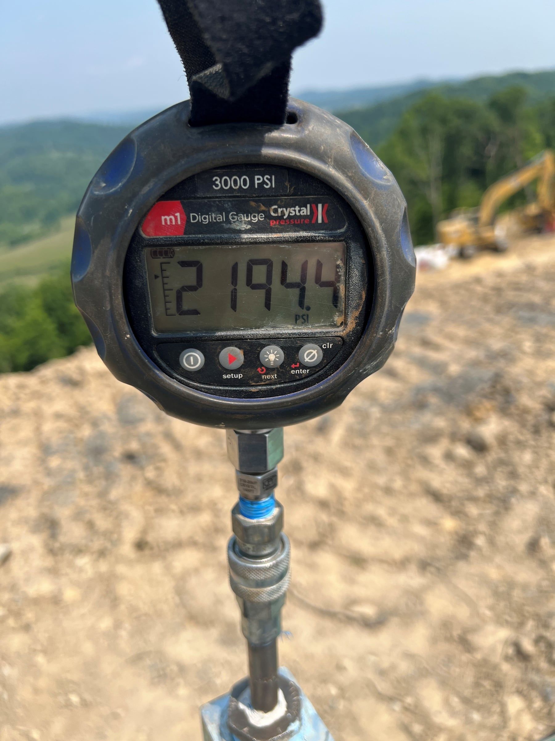 Digital test gauge reading 2,194 psi on a remote stand