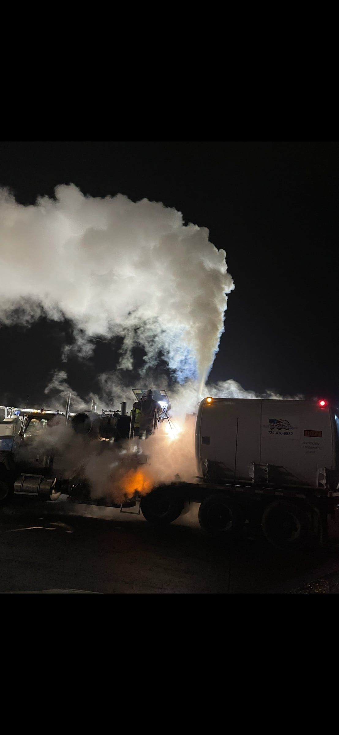 Nitrogen vent plume lit by work lights at night