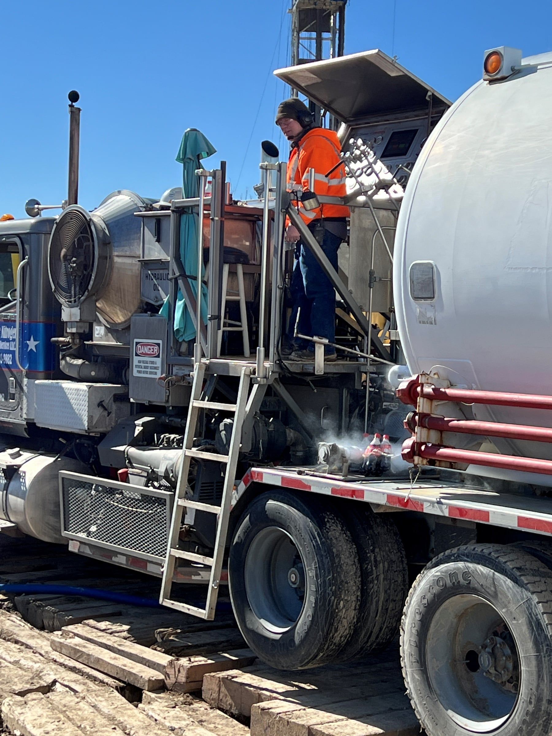 Operator working on the deck of the cryogenic pumper unit