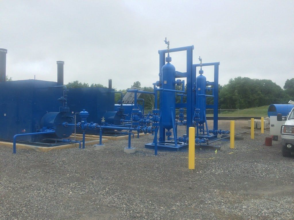 Painted process skid at a station on a misty morning