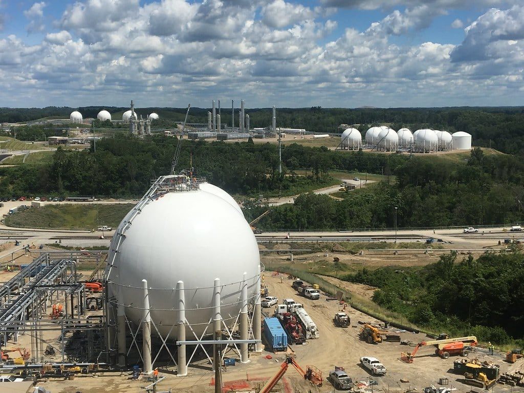 Aerial view of a storage facility with spherical tanks and active construction