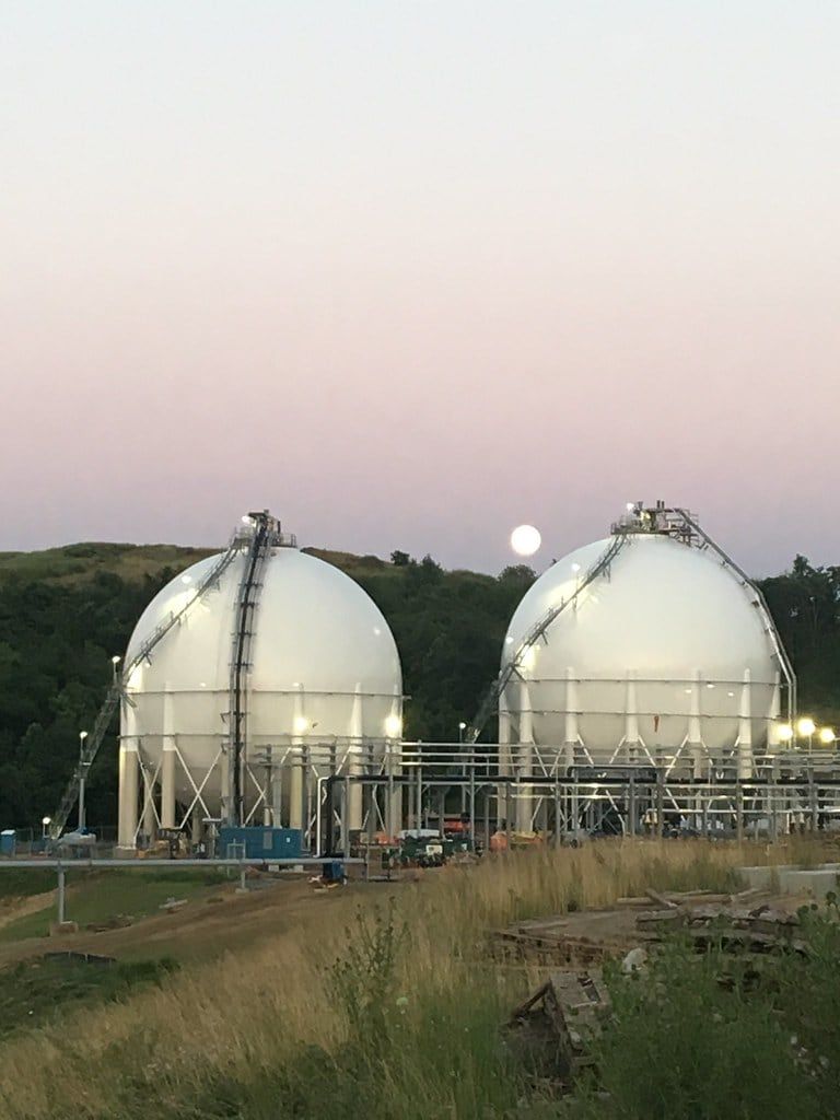Two storage spheres lit at dusk