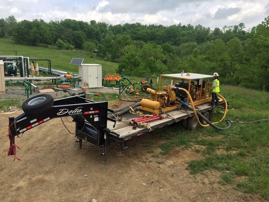 Trailer mounted test skid rigged in to station piping on a gravel pad
