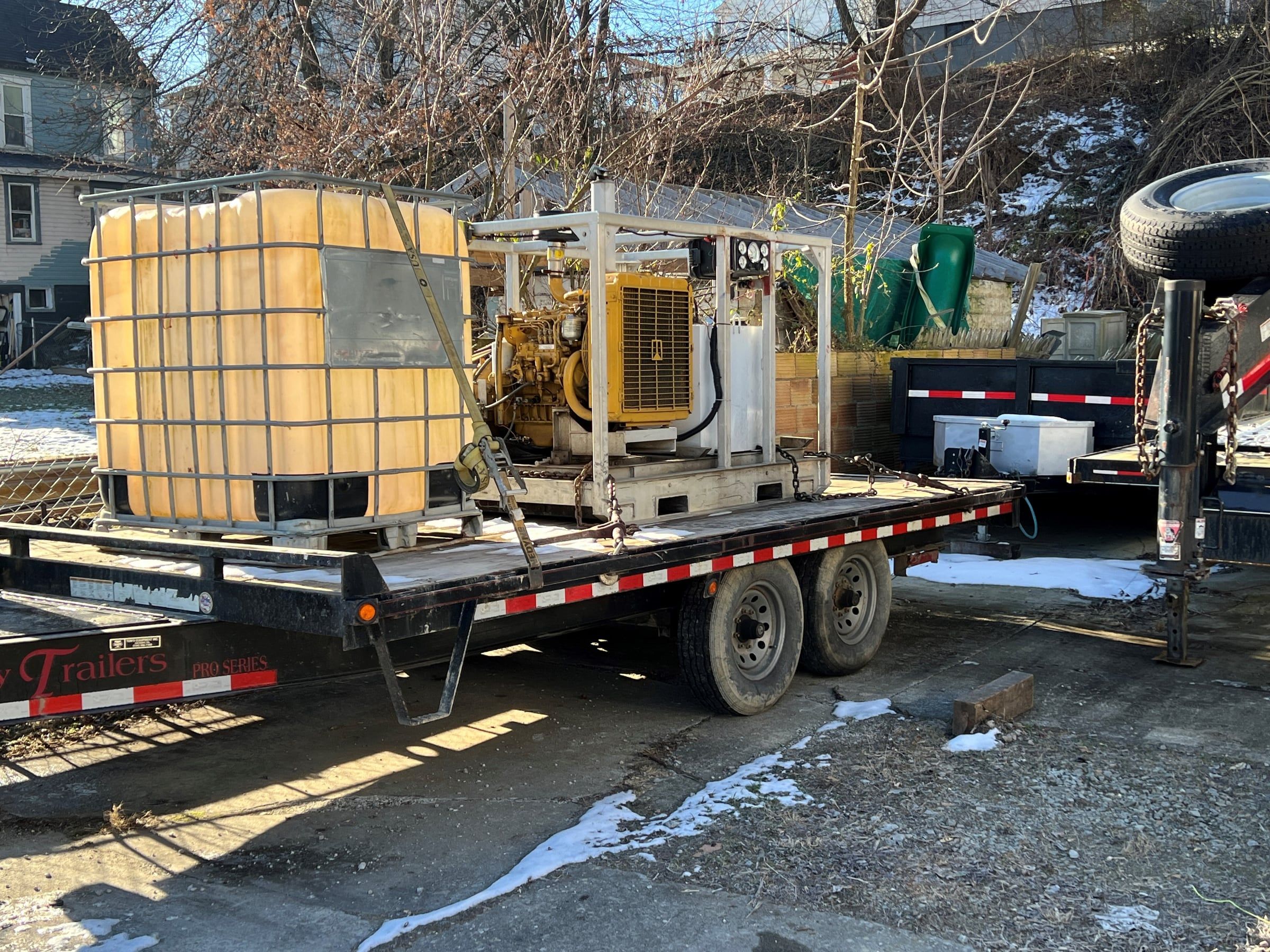 Triplex test pump and water tote loaded on a trailer